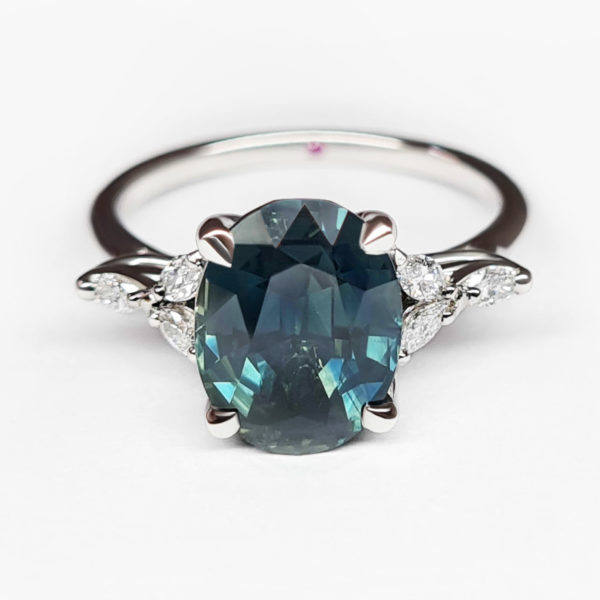 teal ovel sapphire engagement ring with marquise diamonds
