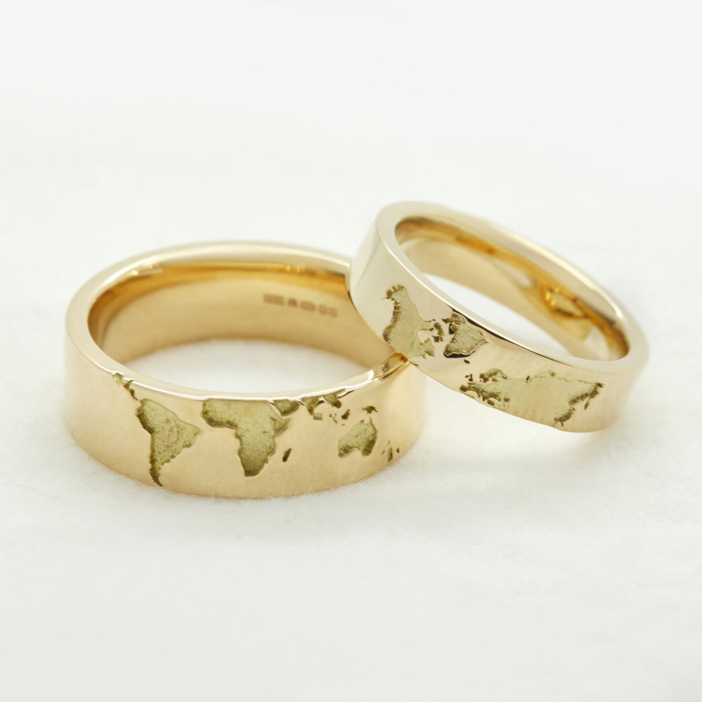 world map engraved matching wedding rings yellow gold