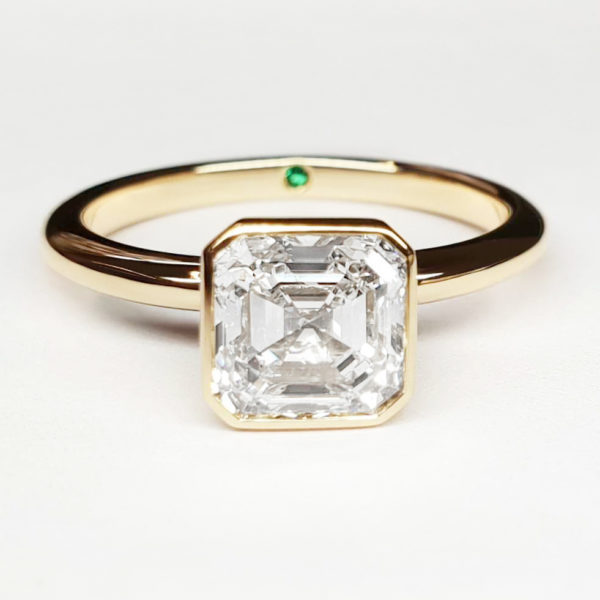Asscher cut diamond bezel set in yellow gold