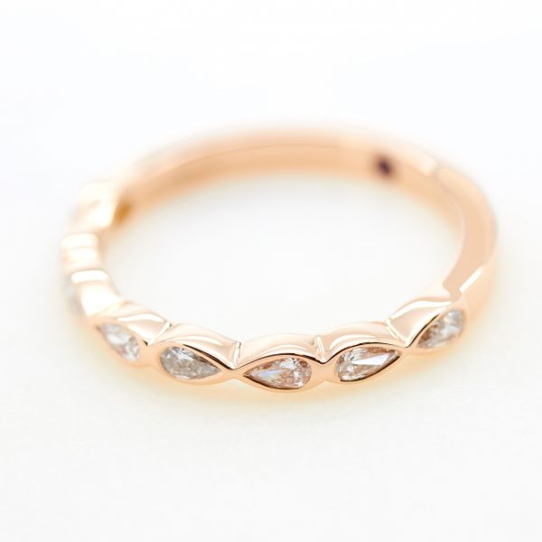 pear shaped diamond bezel set rose gold ladies wedding band