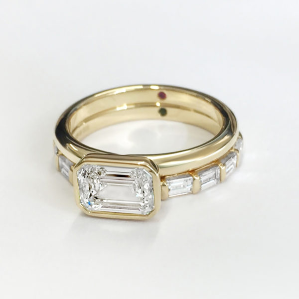 Emerald cut diamond east west setting set in yellow gold