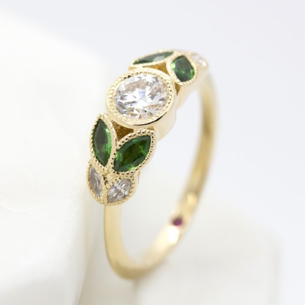 bezel set round diamond with marquise emeralds and diamonds yellow gold organic engagement ring