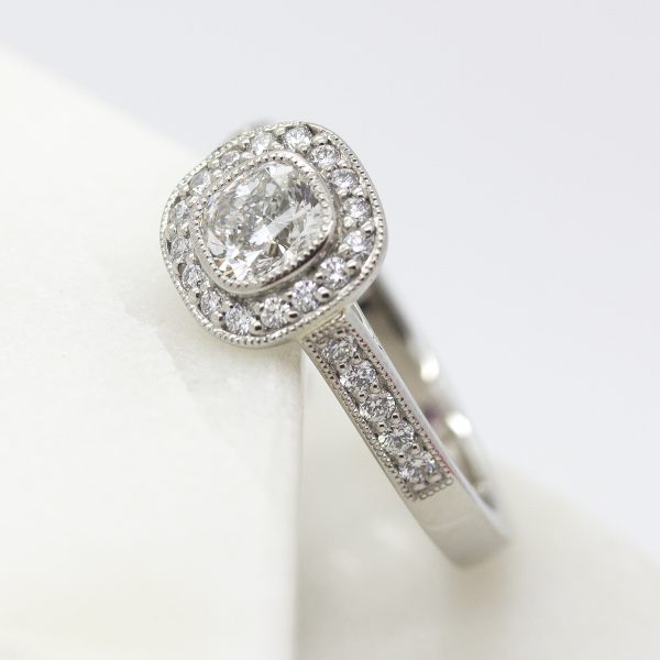 cushion cut diamond halo engagement ring with milgrain