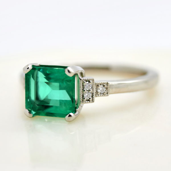 emerald cut emerald with side accent stones trilogy engagement ring