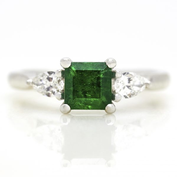 emerald with pear diamond side stone trilogy engagement ring