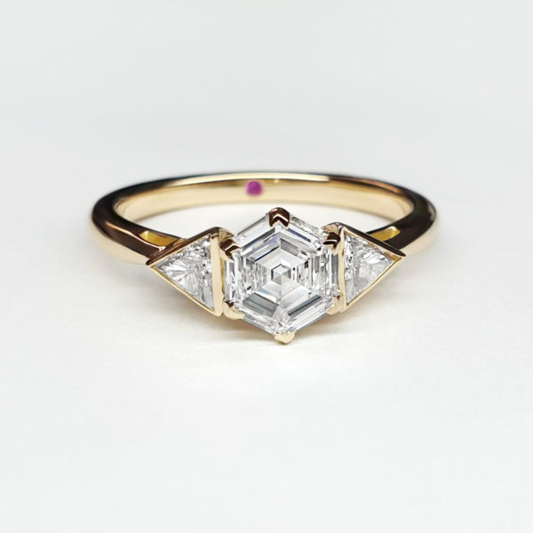 A hexagon diamond set in yellow gold with trillion diamonds