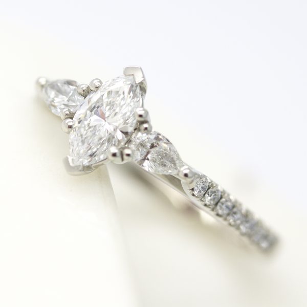 marquise cut diamond with pear accent stones and diamond pave band