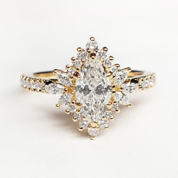 Marquise diamond cluster engagement ring set in yellow gold