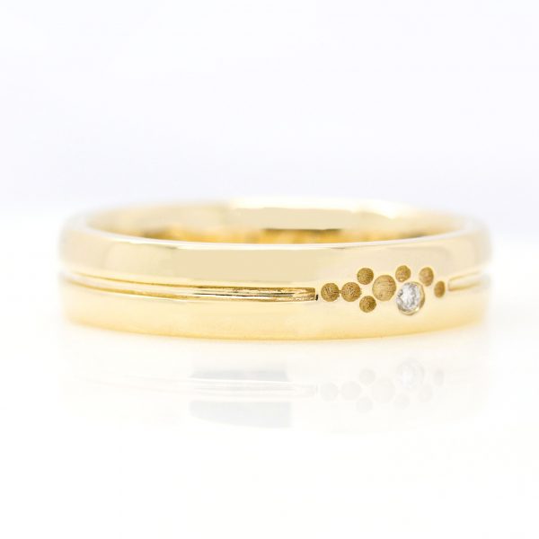 mens yellow gold wedding ring with engraving and small round diamond