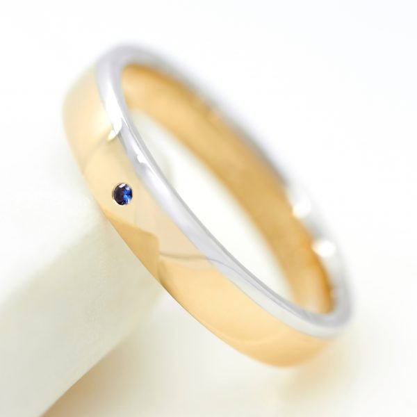 mixed metal mens wedding ring with a round blue sapphire