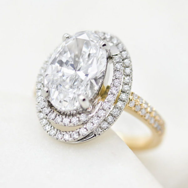 oval diamond twisted diamond halo engagement ring yellow gold platinum mixed metal