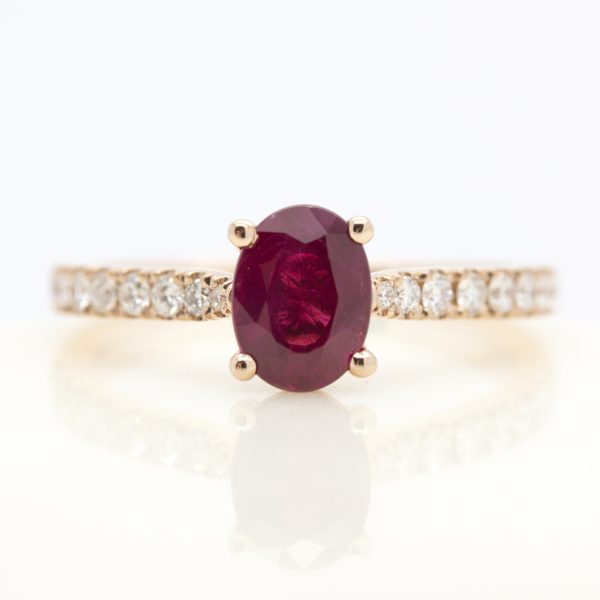 oval ruby engagement ring with pave diamond band in rose gold
