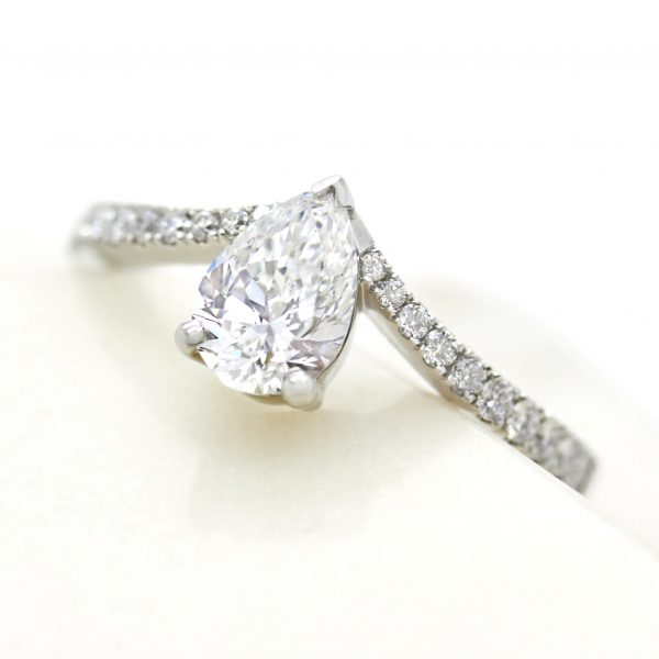 pear diamond engagement ring with chevron pave diamond band