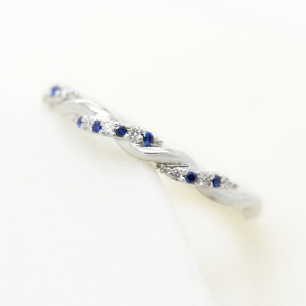 Twisted platinum wedding with with sapphire and diamond pavé
