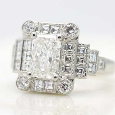 Radiant cut diamond with round and carre cut diamond halo set in platinum