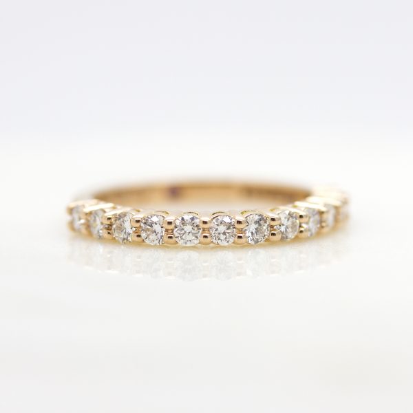 rose gold wedding ring with shared prong set round diamonds