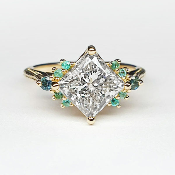 Rotated princess cut diamond yellow gold engagement ring with small round paraiba tourmaline accent stones