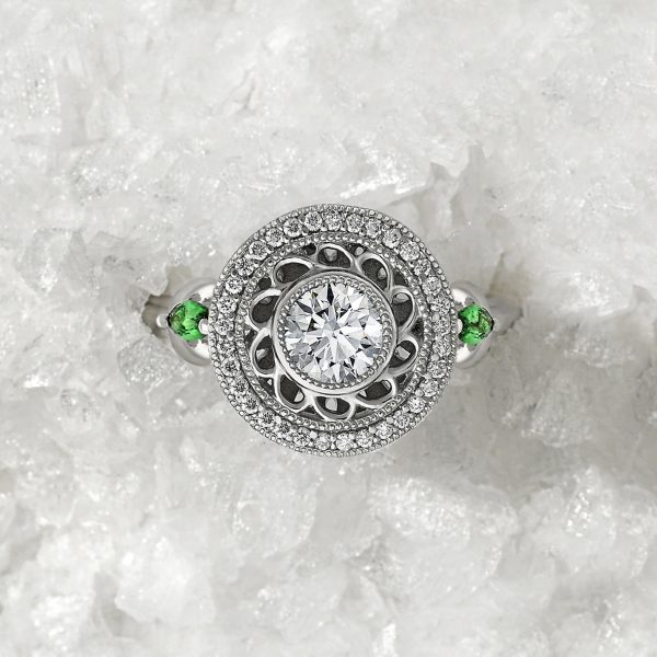 round diamond with filigree detail halo with marquise tsavorites in platinum engagement ring