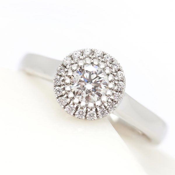 round diamond halo engagement ring with bead setting and plain polished platinum band