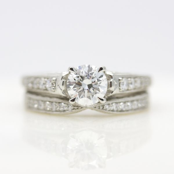 round diamond with bead set diamond band and matching wedding ring