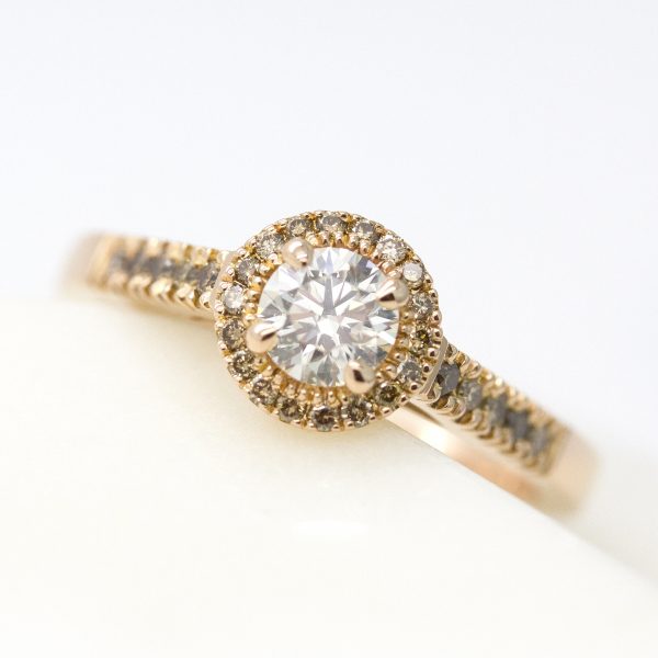 round diamond with cognac diamond halo and pave band set in rose gold