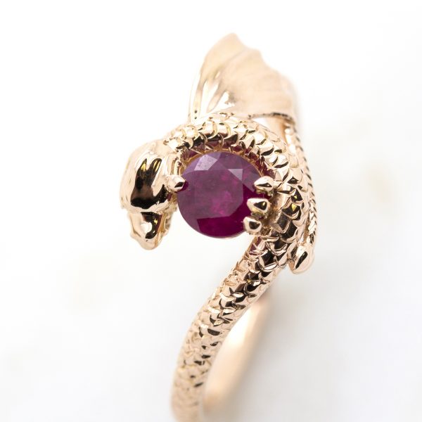 round ruby centre with dragon inspired setting and hand engraving in rose gold