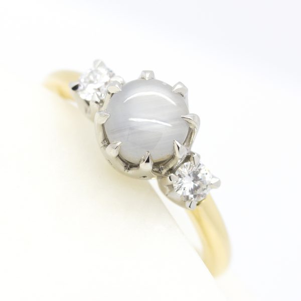 round starlight sapphire trilogy engagement ring with eagle claws and mixed metal