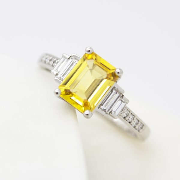 emerald cut yellow sapphire with side diamond baguettes and beat set diamond band