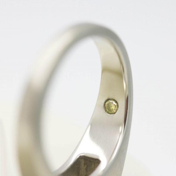 yellow diamond set on the inside of a band