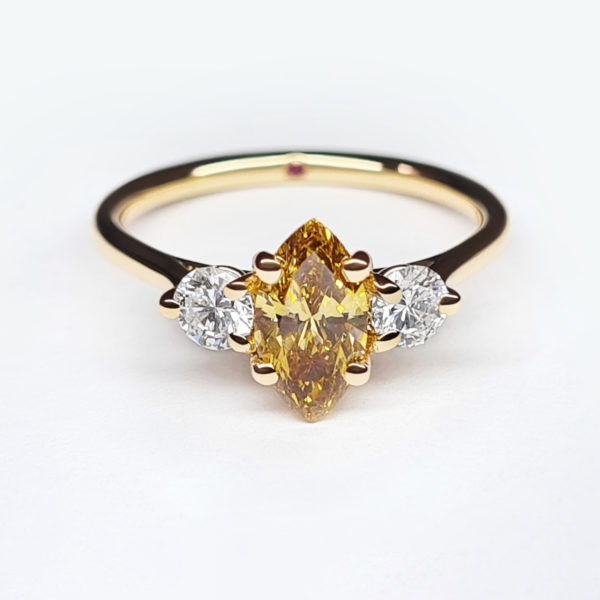 Yellow marquise diamond set in yellow gold with pear diamond accent stones